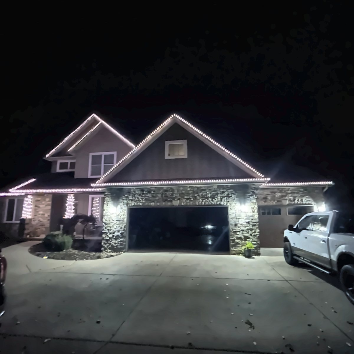 Two-story home with warm white C9 bulbs tracing every peak